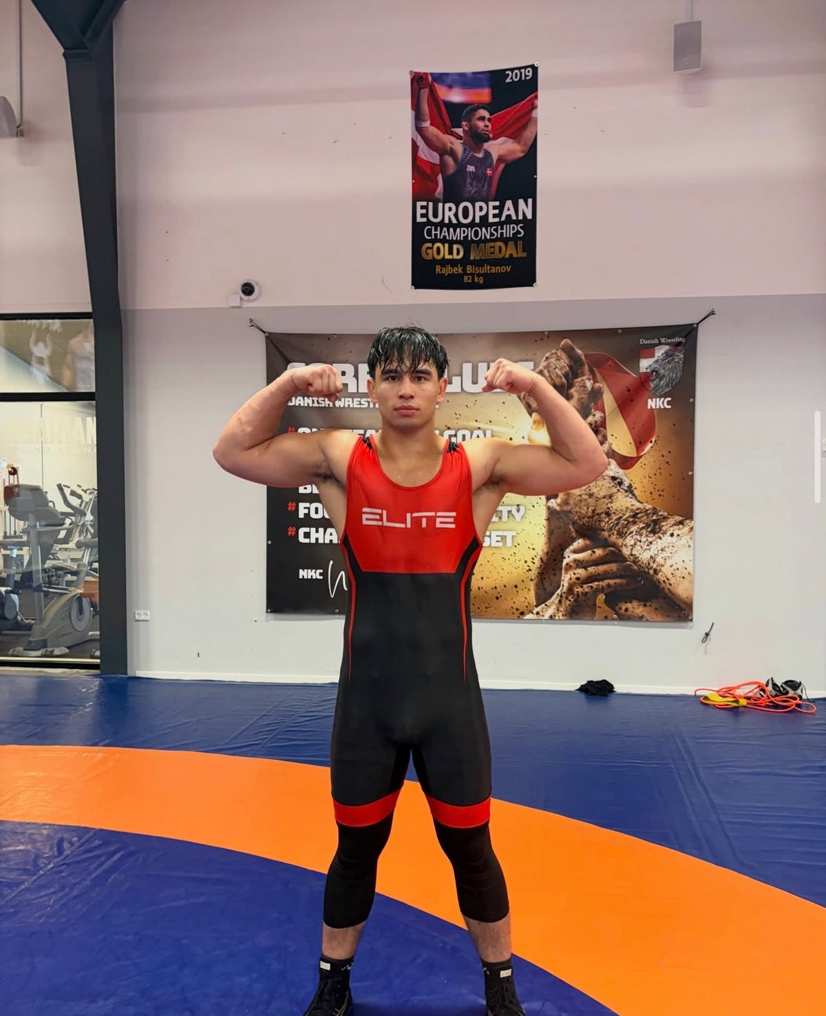 Wearing Elite Wrestling Singlet
